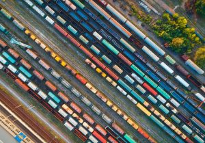 This image has an empty alt attribute; its file name is top-view-of-colorful-cargo-trains-aerial-view-300x209-1.jpg